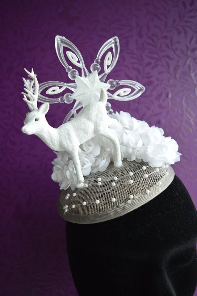 IMAGE - Silver sinamay fascinator with white flowers, dear and snowflake. Finished with strings of pearls. Fixes to hair with a comb.