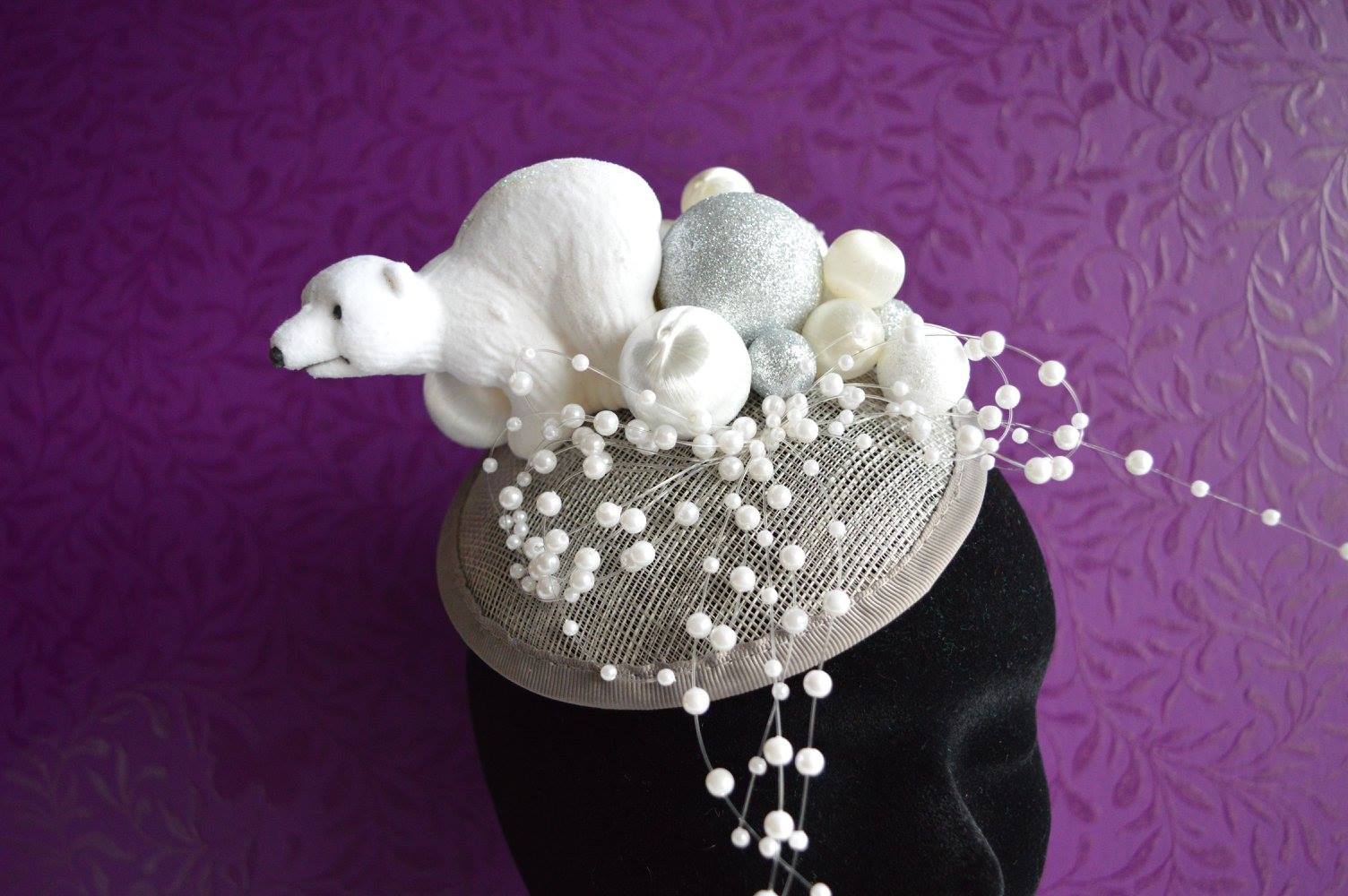 IMAGE - Silver sinemay fascinator with polar bear and silver and white spheres, decorated with strings of pearls. Fixes to hair with a comb.