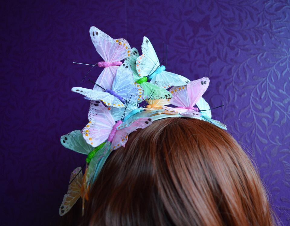 IMAGE - Babyblue satin headband decorated with pastel coloured butterflies.