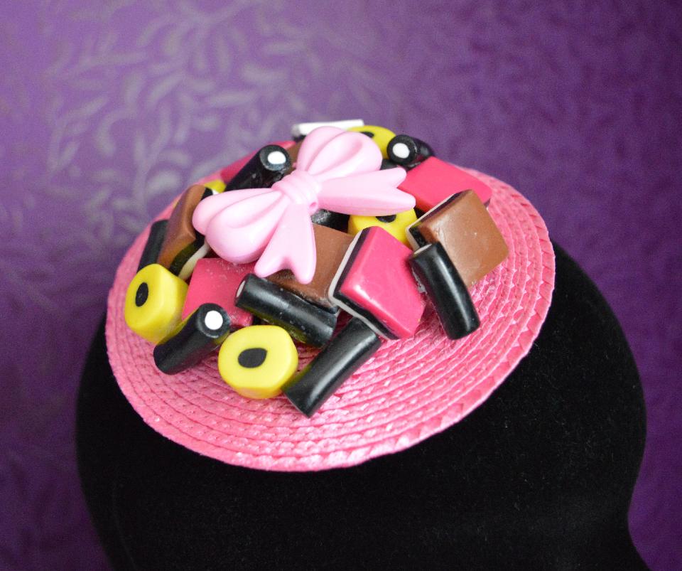 IMAGE - Pink fascinator with polymer clay licorice and plastic bow.
Fixes to hair with comb.