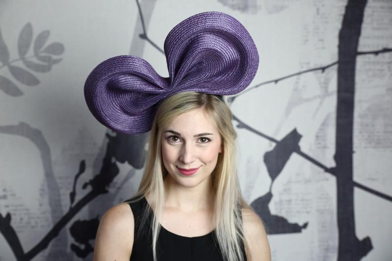 IMAGE - Giant purple straw bow, sits on a headband.