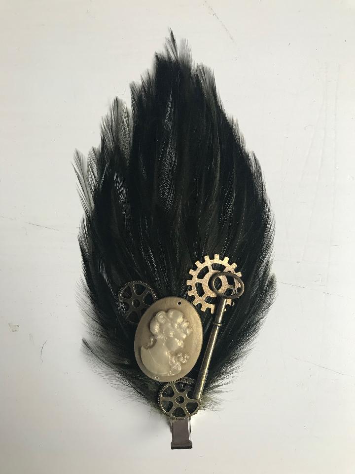 IMAGE - Dark green featherpad with gold cameo, bronze gears and key.